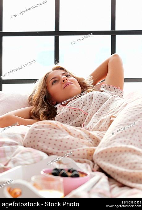 Lifestyle, home. Girl lying in bed