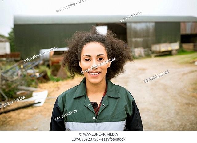 Happy woman standing near barn