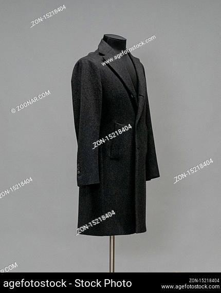 Black coat on a mannequin in the studio on gray background