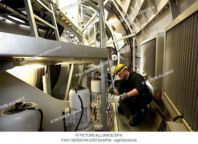 24 April 2018, Germany, Driedorf: Controller Christoph Lober checking the actuators of a wind turbine. The machines, rotor blades and the supporting structure...