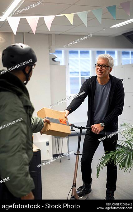 Bicycle courier delivering parcel