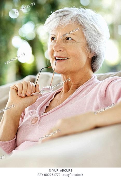 Relaxed senior woman deep in thought