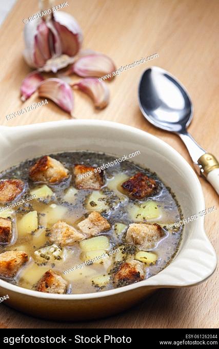 garlic soup with toasted bread and potatoes