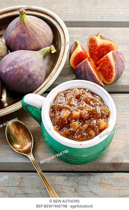 Jug of fig jam and bowl of fresh figs. Healthy fruits