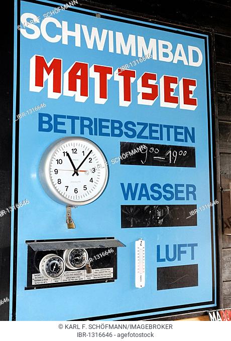 Historic lido from 1927, sign with operating times and water and air temperatures, with clock, Mattsee, Flachgau, Salzburger Land region, Salzburg, Austria