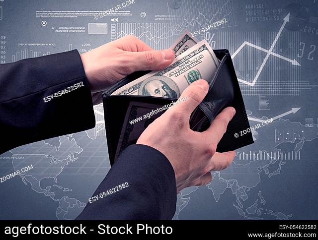 Businessman's hand takes out dollar from wallet with finance graphic on the background