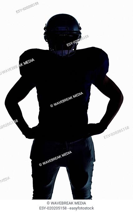 Silhouette American football player standing with hand on hip
