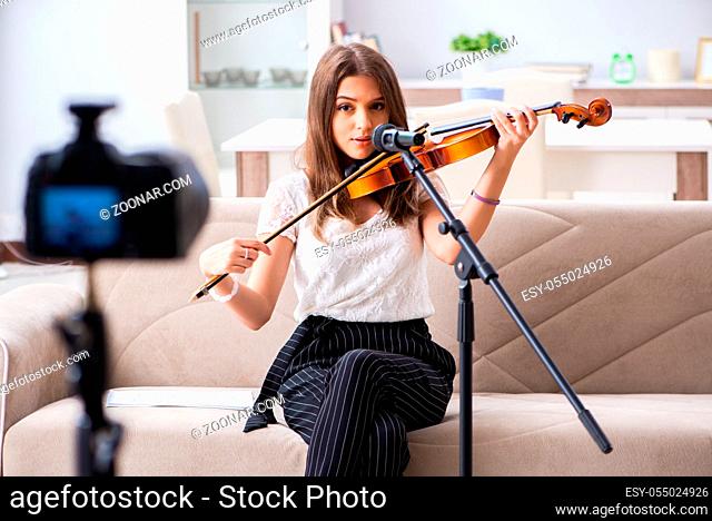 Female beautiful blogger playing violin