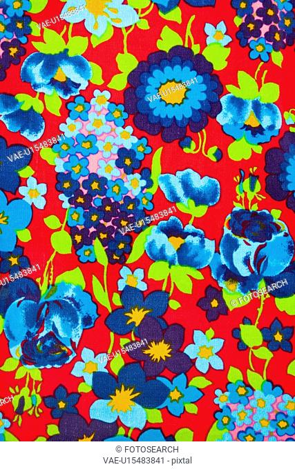 Close-up of vintage fabric with vibrant blue and turquois flowers printed on polyester