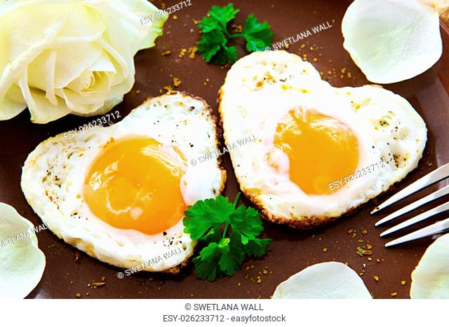 Two heart-shaped fried eggs on a plate.Valentine&#39;s Day breakfast