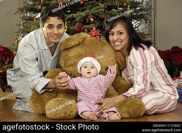 Hispanic parents and baby on Christmas