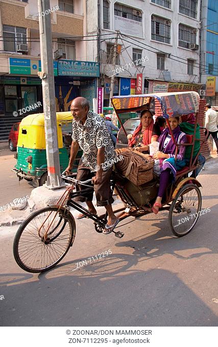 Cycle rickshaw carrying passengers in New Delhi, India