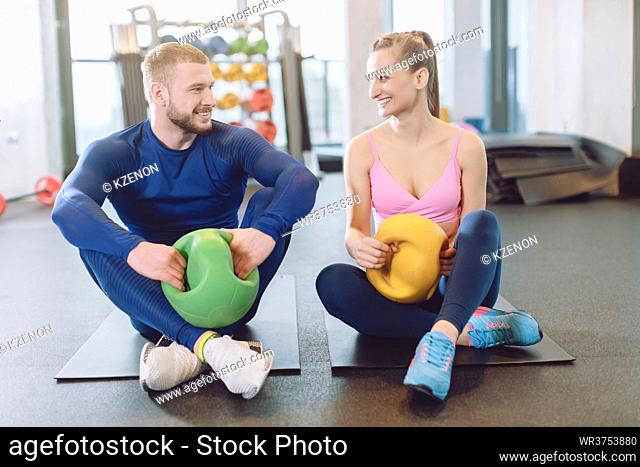 Man and woman doing stomach or abdominal exercises together in core training session