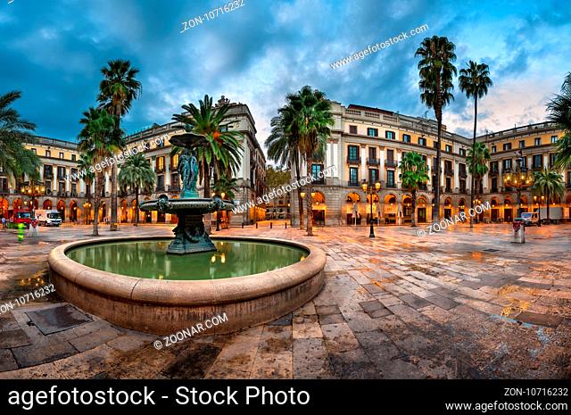 BARCELONA, SPAIN - NOVEMBER 17, 2014: Placa Reial in Barcelona, Spain. The square, with lanterns designed by Gaudi and the Fountain of Three Graces in the...
