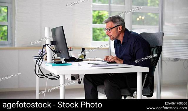 Bad Posture Sitting In Office Chair At Computer Desk