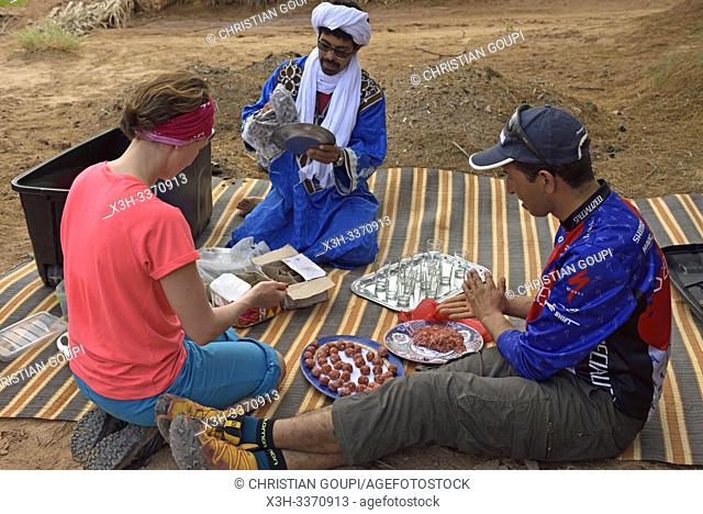 preparation of the lunch of a group of bike hikers near the dunes of Tindouf, Draa River valley, Province of Zagora, Region Draa-Tafilalet, Morocco