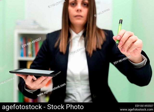 Woman Holding Tablet And Pointing Important Informations With Pen In Hand