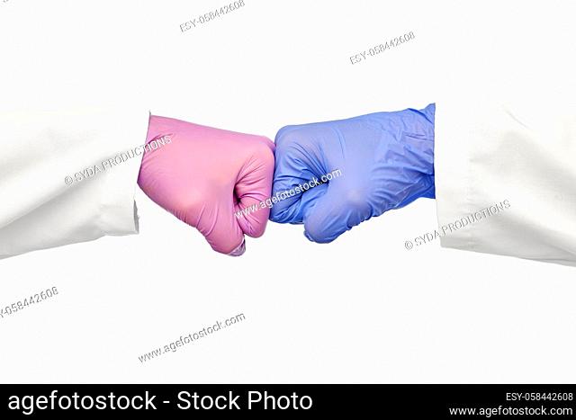 hands of doctors in gloves make fist bump gesture