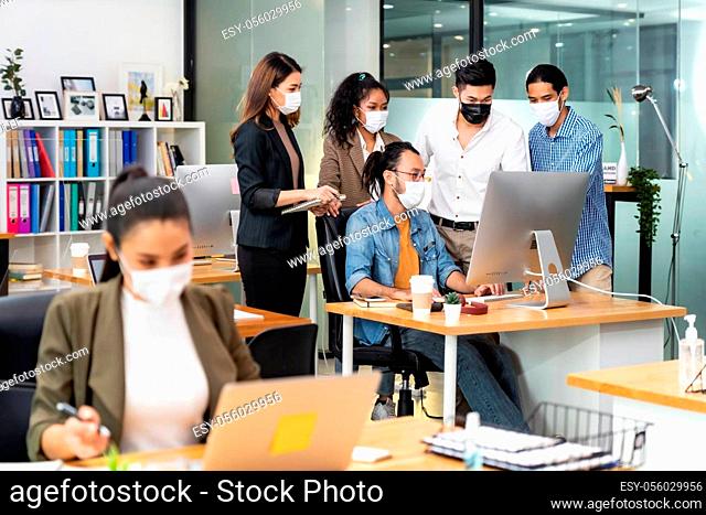 Group portrait of interracial business worker team wear protective face mask in new normal office with social distance practice prevent coronavirus COVID-19...