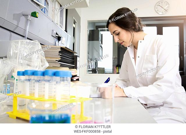 Germany, Berlin, female researcher working in laboratory