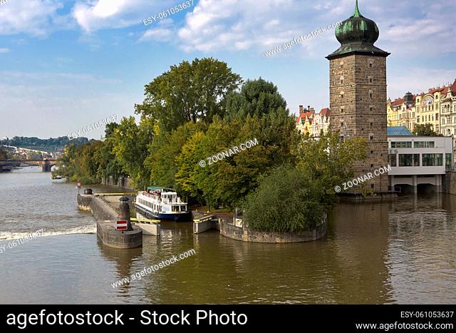 walking tourist ship passes a lock on the Vltava River in Prague, Czech Republic