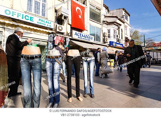 Street scene with Turkish flag, people and jeans for sale on mannequins in Istanbul, Turkey