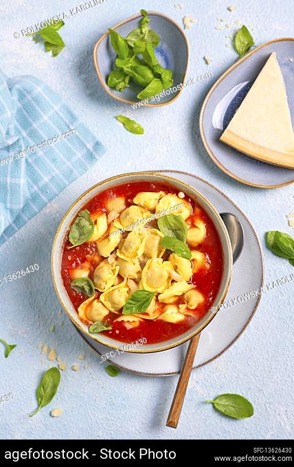 Thick tomato soup with tortellini parmesan basil