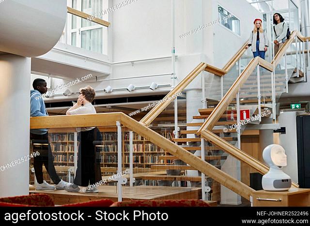 Students on stairs in library