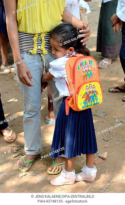 A girl hugs her mother at the Kdei Chas Primary School in Phnom Penh, Cambodia, 11 October 2013. Toilets, water and sanitation facilities have been built at the...