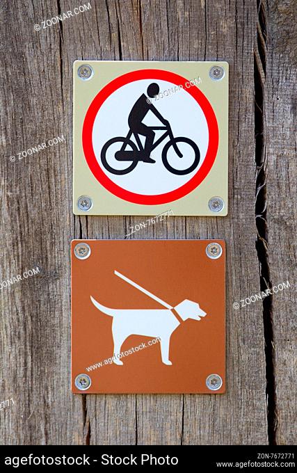 Forbidden to cycle an dog on a leash sign
