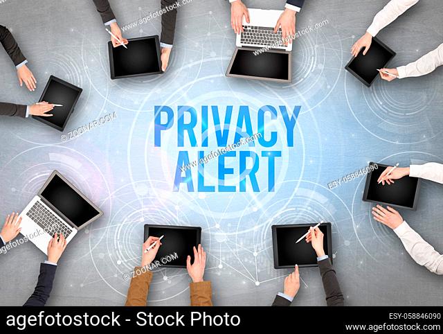 Group of people in front of a laptop with PRIVACY ALERT insciption, web security concept