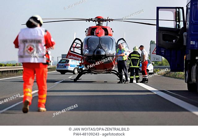 A rescue helicopter waits to take off at the sight of an accident on the A 14 motorway near Tornau, Germany, 24 April 2014