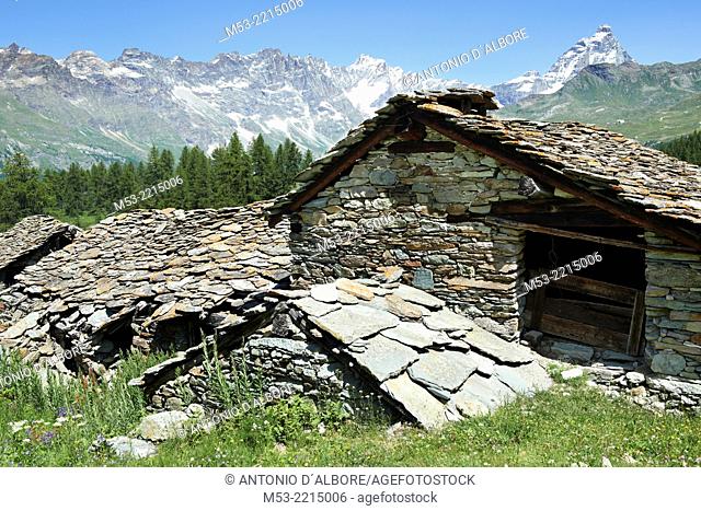 An old rascard home in Cheneil with roof in slate slabs. the peak in the background is the Matterhorn. Graian Alps. Valle d'Aosta. Italy