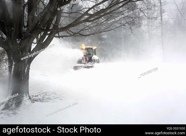 snowblower blowing snow from driveway during blizzard. Meaford; Ontario; Canada