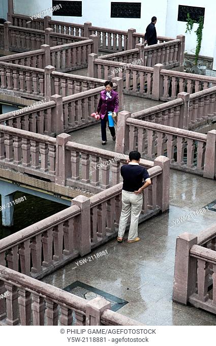Zigzagging bridge crosses an ornamental lake at the Yu Bazaar, Shanghai, China. There is free access to this area, which is not a paid attraction