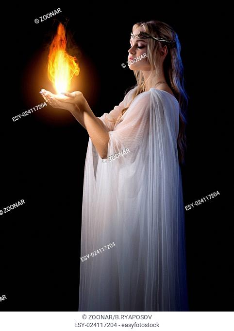 Young elven girl holding fire in palms isolated