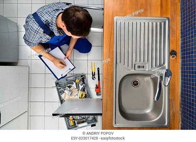 Plumber Examining Kitchen Sink