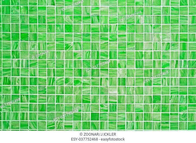 A green square tiled background with small mosaic