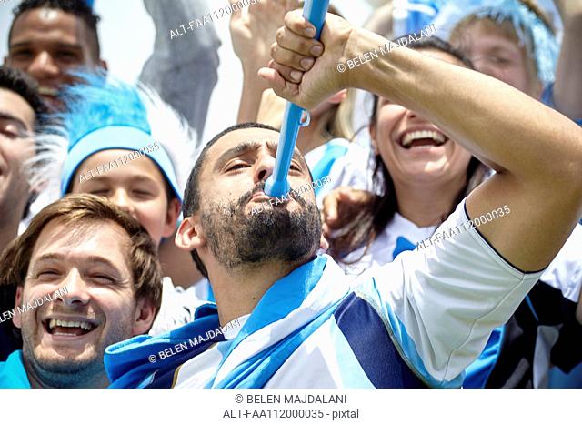Argentinian football fan playing vuvuzela at match