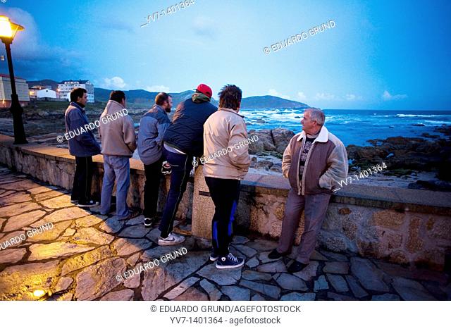 Barnacles Fishermen at dawn in Muxia's fishing port Coruña, Galicia, Spain