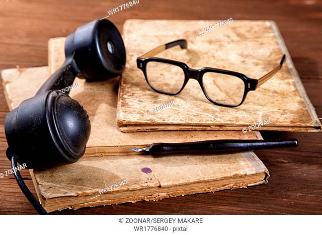 Still-life with old writing-books a nib and phone