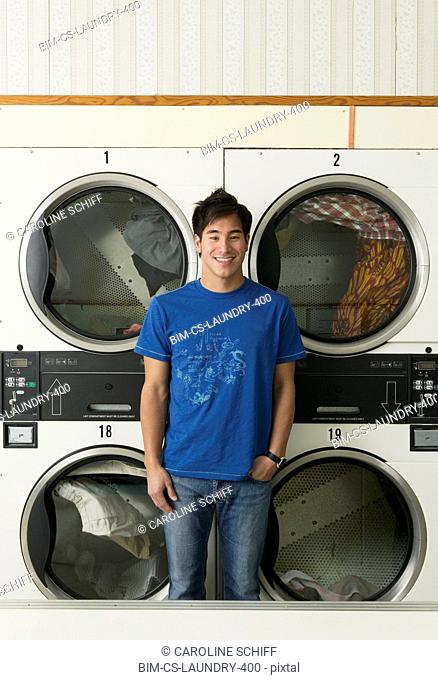 Asian man in Laundromat