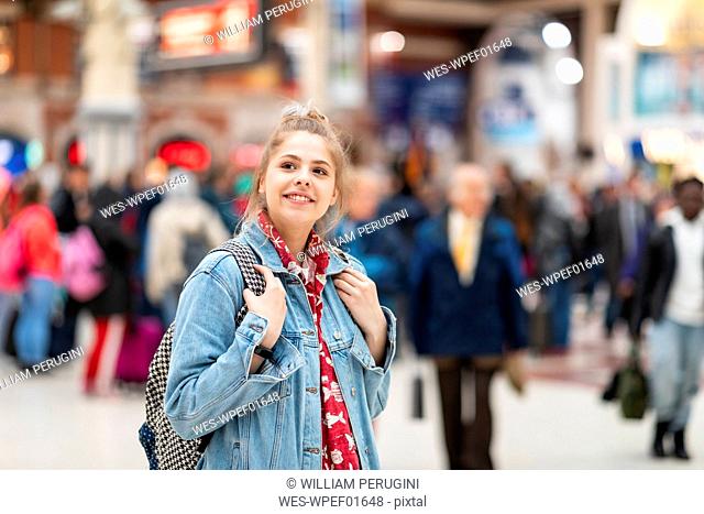Smiling young woman at the train station