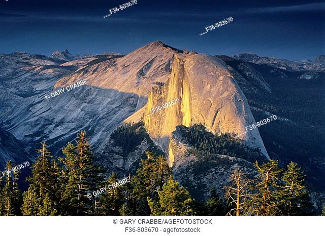 Sunset light through storm clouds on Half Dome, from atop Sentinel Dome, Yosemite National Park, CALIFORNIA
