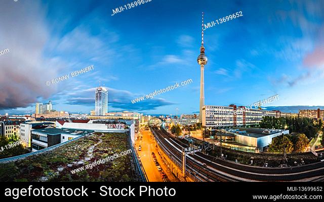 Traces of light from the night traffic in Berlin in front of the television tower and Alexanderplatz
