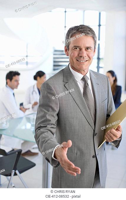 Businessman offering handshake in meeting