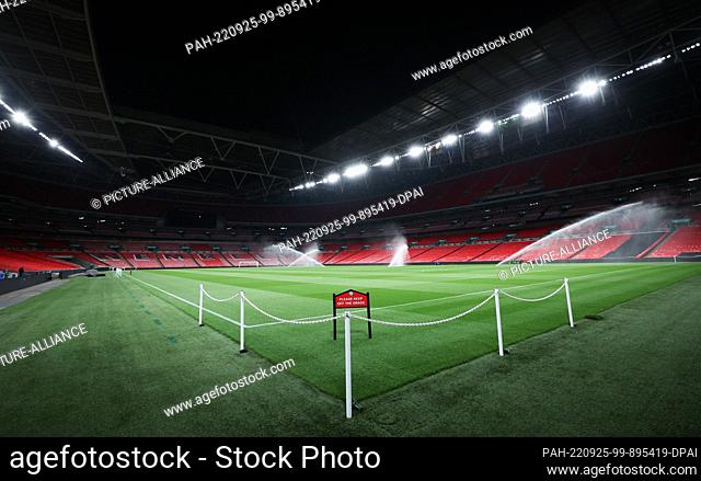25 September 2022, Great Britain, London: Soccer: Nations League A, before the match England - Germany. The turf at Wembley Stadium is watered the night before...