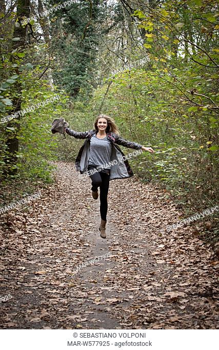 woman jumping in forest