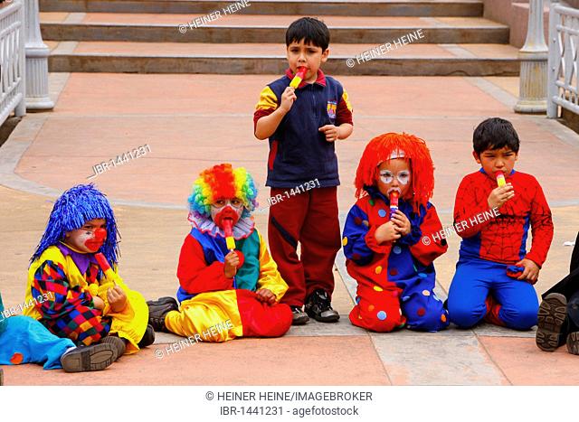 Dressed-up children having ice cream, Mapuche Indians, Temuco, southern Chile, Chile, South America