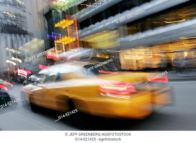 Yellow taxi cabs, blur, motion, movement, speed. Avenue of the Americas. Midtown Manhattan. New York. USA